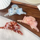 Beau double layer bow hair claw clip held in hand showing size and scale