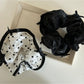 Side view of Gifty elegant bow tulle scrunchie highlighting sheer fabric and elastic band