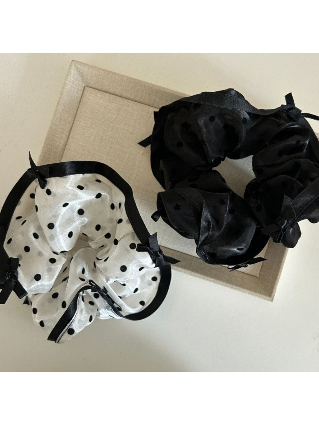 Side view of Gifty elegant bow tulle scrunchie highlighting sheer fabric and elastic band