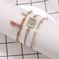 Lovra bracelet with gold tassel pendant and small round beads in natural light
