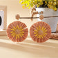 Top view of sunflower earrings highlighting the petal texture and color contrast
