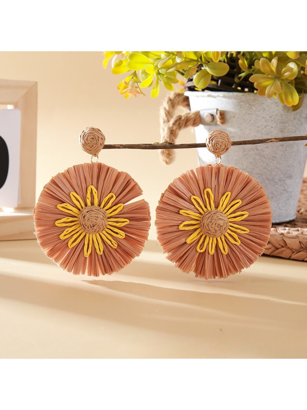 Top view of sunflower earrings highlighting the petal texture and color contrast