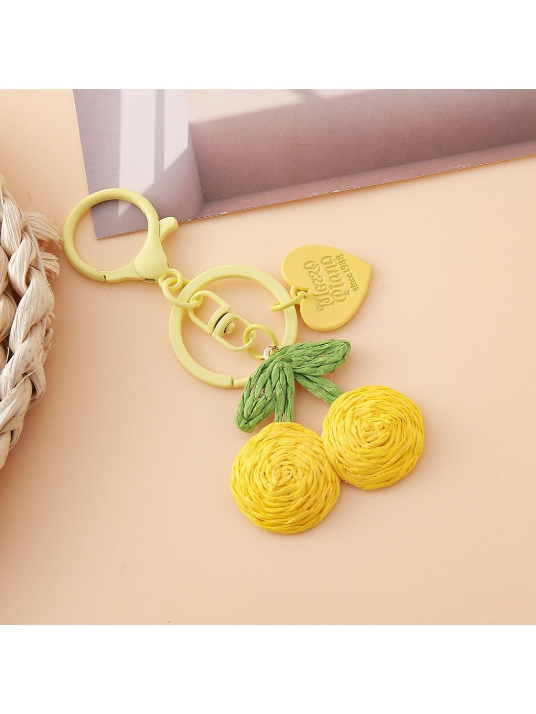 Hand holding the Keypus cherry charm keychain showing its size and details