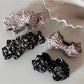 Beau small bow hair clip with pink and white floral print on fabric
