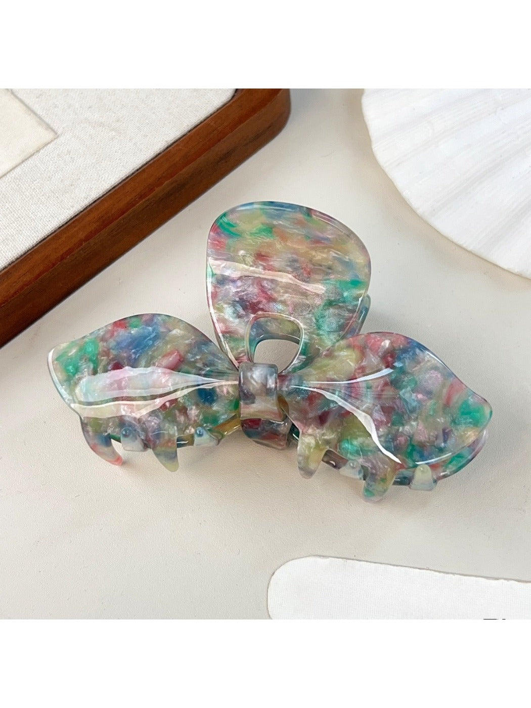 Beau bow hair claw clip held in hand to show size and scale