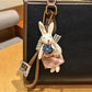 Top view of rabbit charm keychain highlighting smooth metal finish