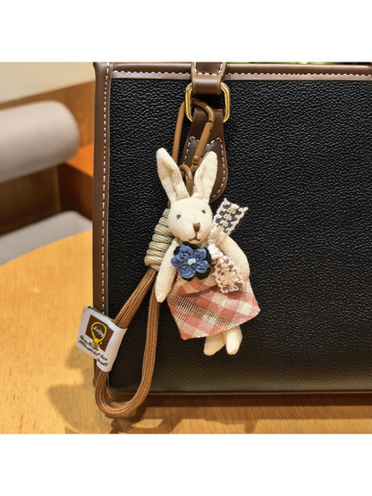 Top view of rabbit charm keychain highlighting smooth metal finish