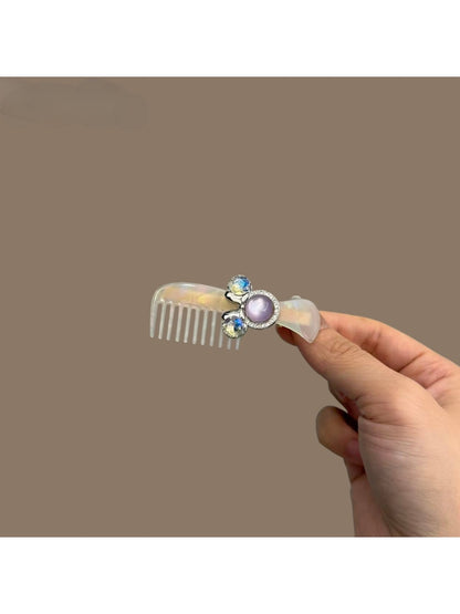 Close-up of Beau acetate comb-shaped hair clip showing glossy finish and pattern