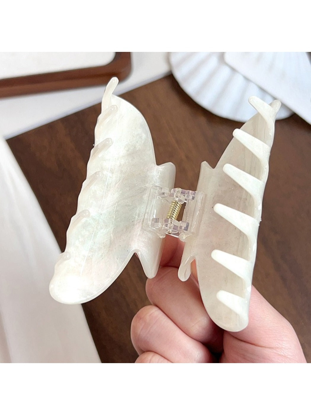 Beau hair claw clip holding thick brown hair in a half-up style
