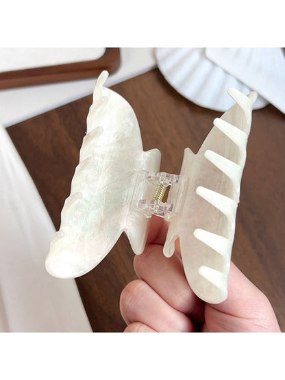 Beau hair claw clip holding thick brown hair in a half-up style