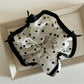 Flat lay of Gifty bow tulle scrunchie alongside matching hair accessories on neutral background