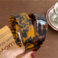 Close-up of Gifty acetate headband showing geometric design and glossy finish