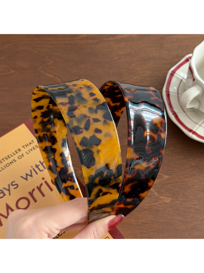 Close-up of Gifty acetate headband showing geometric design and glossy finish