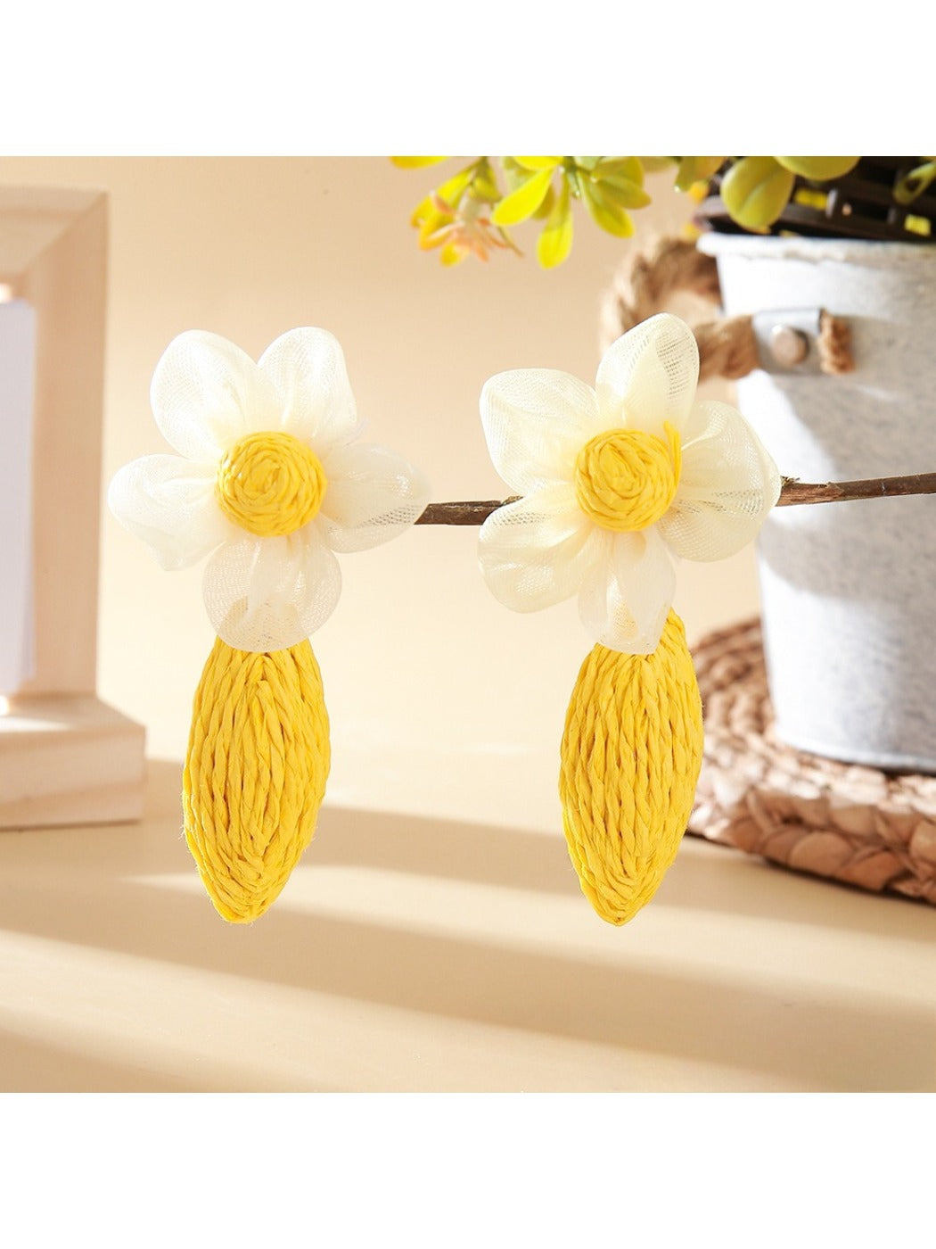 Close-up of earring hooks attached to raffia lace flower shapes