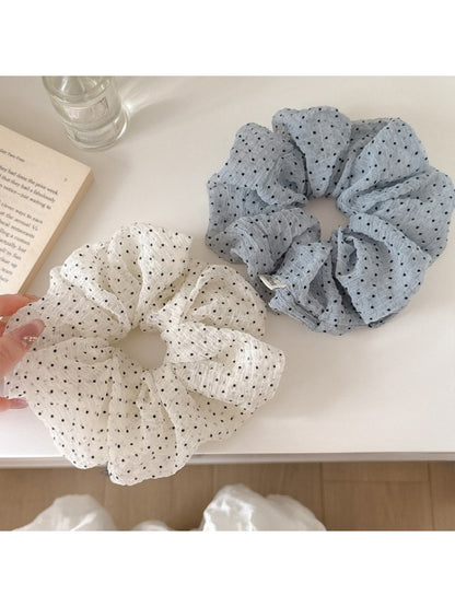 Close-up of Gifty tulle scrunchie showing delicate polka dot pattern