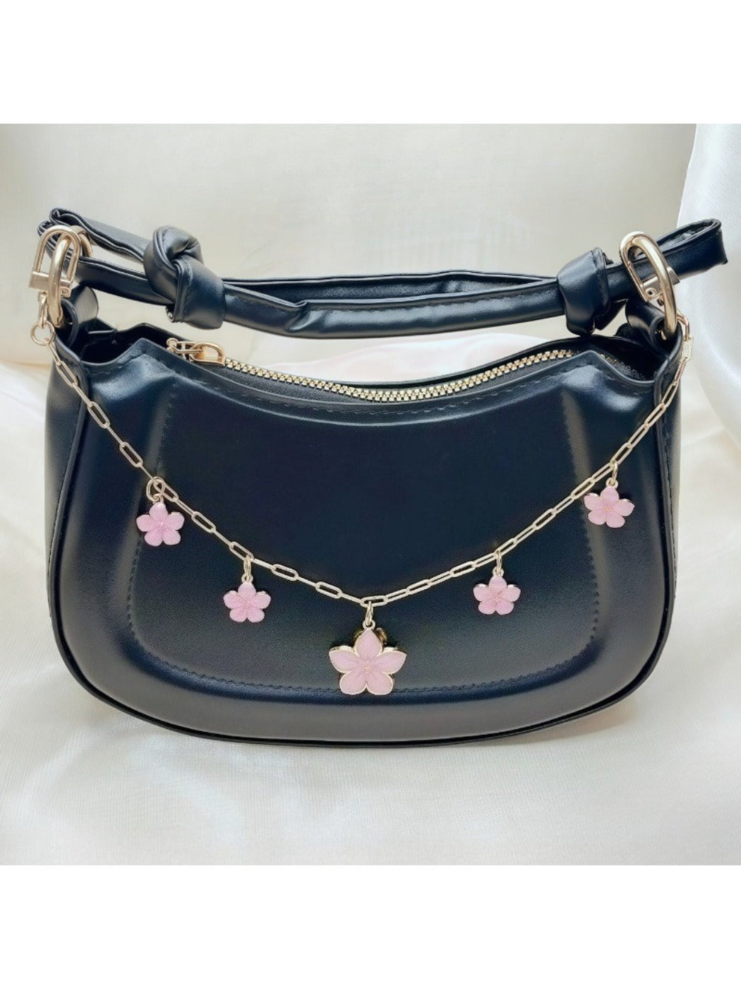 Close-up of cherry blossom pendant showing detailed pink petals and silver accents