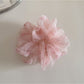 Gifty hair scrunchie worn on wrist alongside casual outfit accessories