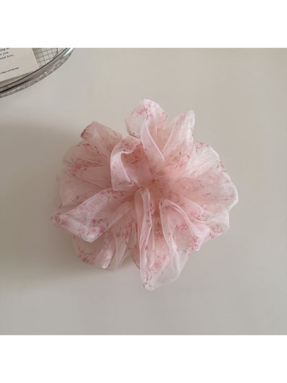 Gifty hair scrunchie worn on wrist alongside casual outfit accessories