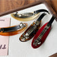 Side view of Beau acetate ponytail hair clip highlighting oval shape and clasp details