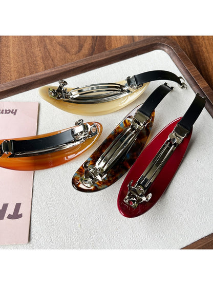 Side view of Beau acetate ponytail hair clip highlighting oval shape and clasp details