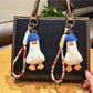 Blue duck-shaped keychain with soft hair texture on a white background
