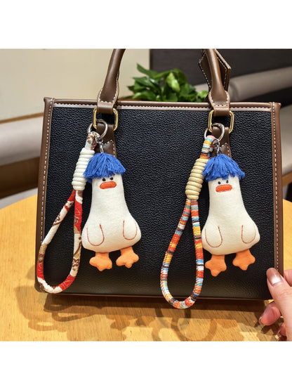 Blue duck-shaped keychain with soft hair texture on a white background