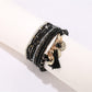 Side view of Lovra bracelet highlighting bead texture and metal tassel detail