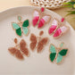 Close-up of Earedge elegant butterfly shaped drop earrings in silver