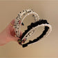 Vintage style tulle headband with layered fabric and decorative bow in soft pastel color