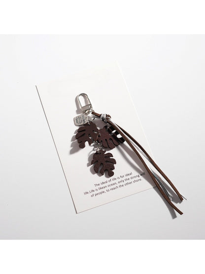 Keypus leaf shaped keychain held in hand showing size and texture