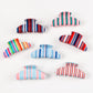 Side view of Beau striped half moon claw clip highlighting curved shape
