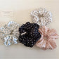 Gifty ditsy floral scrunchie worn on a wrist showing delicate floral pattern and soft fabric texture