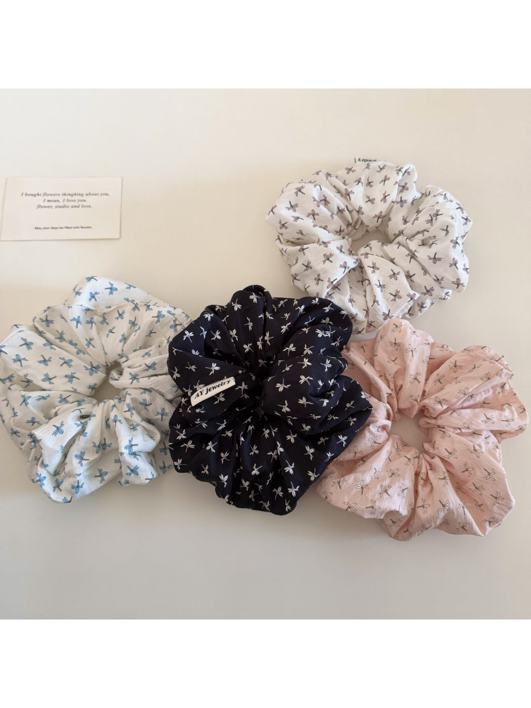 Gifty ditsy floral scrunchie worn on a wrist showing delicate floral pattern and soft fabric texture