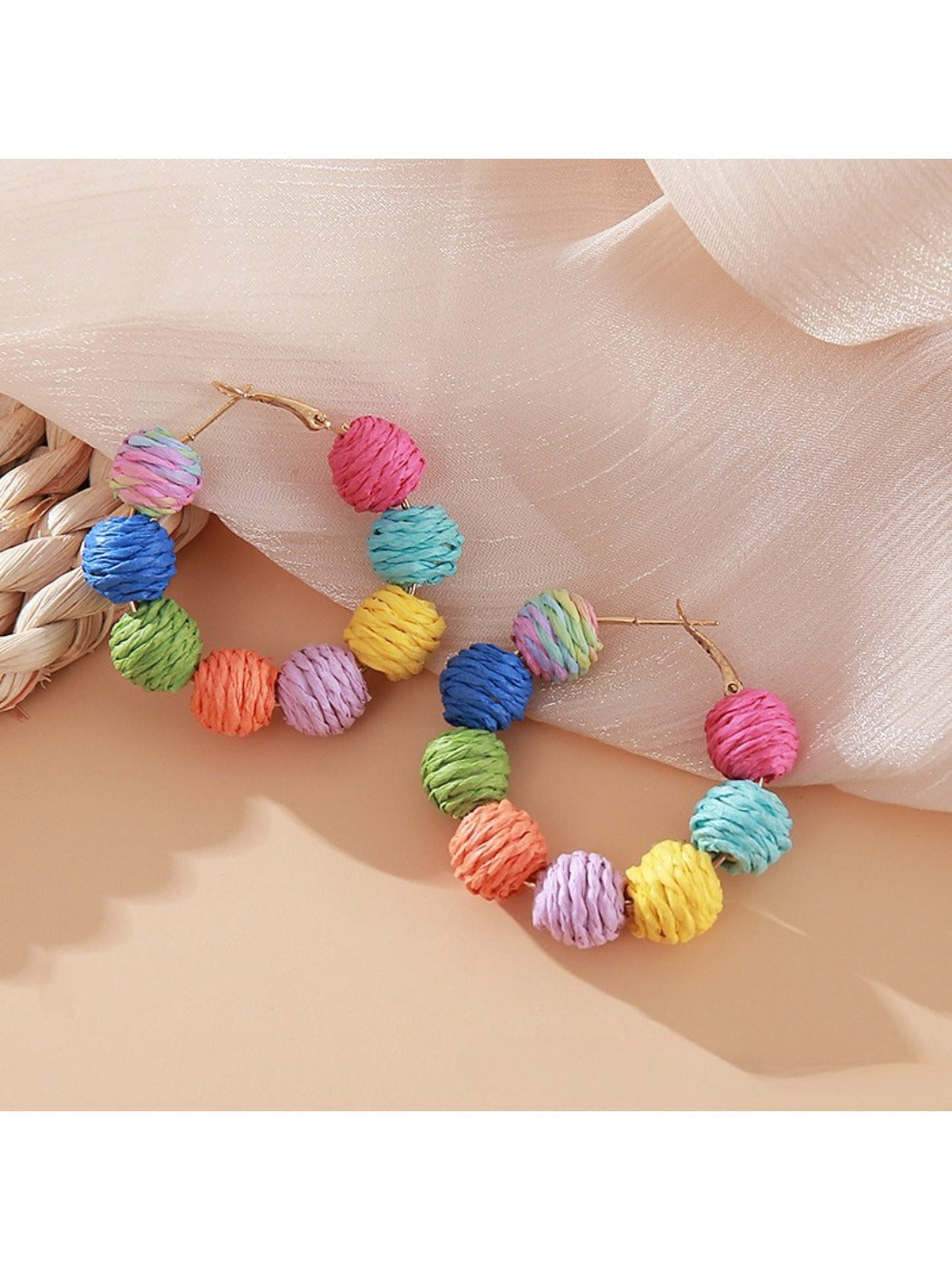 Side view of Earedge raffia round ball drop earrings showing woven texture
