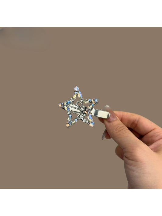 Close-up of Beau rhinestone five point star hair clip with sparkling clear stones