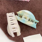 Beau hair claw clip open to display claw teeth and spring mechanism