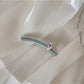 Beau chic flat hair clip shown from above with shadow on white background