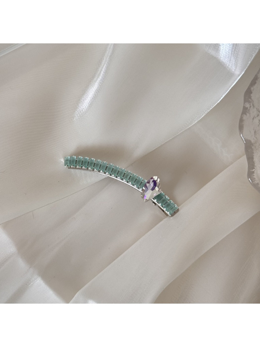 Beau chic flat hair clip shown from above with shadow on white background