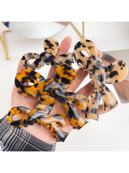 Close-up of Beau bow shaped hair claw clip showing smooth matte finish