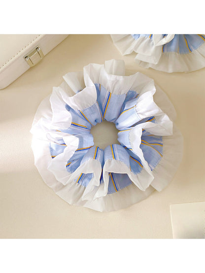 Close-up of blue striped fabric and ruffle details on scrunchie