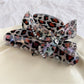 Side profile of Beau claw clip with detailed butterfly and leopard print