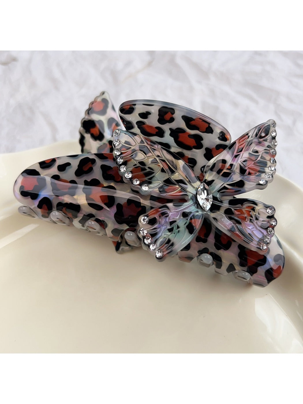 Side profile of Beau claw clip with detailed butterfly and leopard print