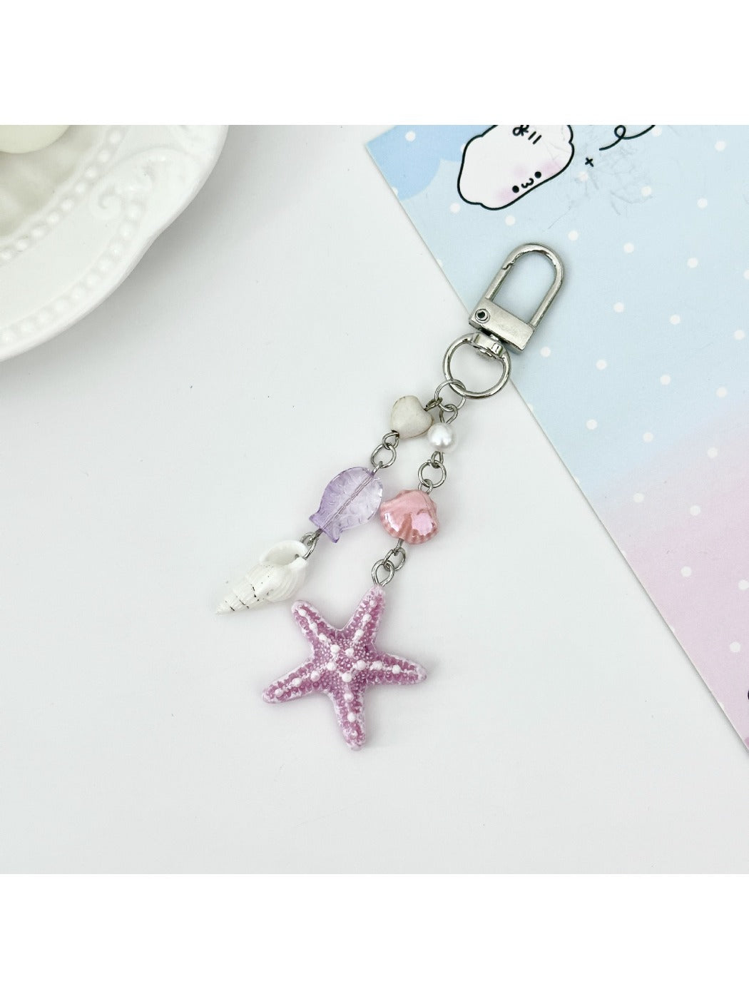 Starfish pendant keychain on a keyring with a blurred background
