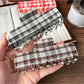 Close-up of Beau plaid fabric pattern on the updo claw clip