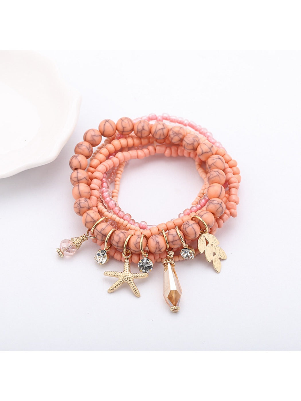 Lovra bracelet with ocean pendant and alternating blue and white beads close-up