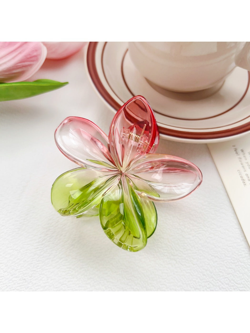 Beau colorful flower claw clip placed on wooden surface with natural lighting