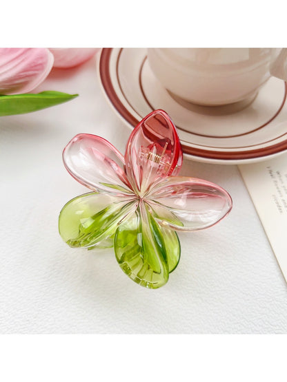 Beau colorful flower claw clip placed on wooden surface with natural lighting