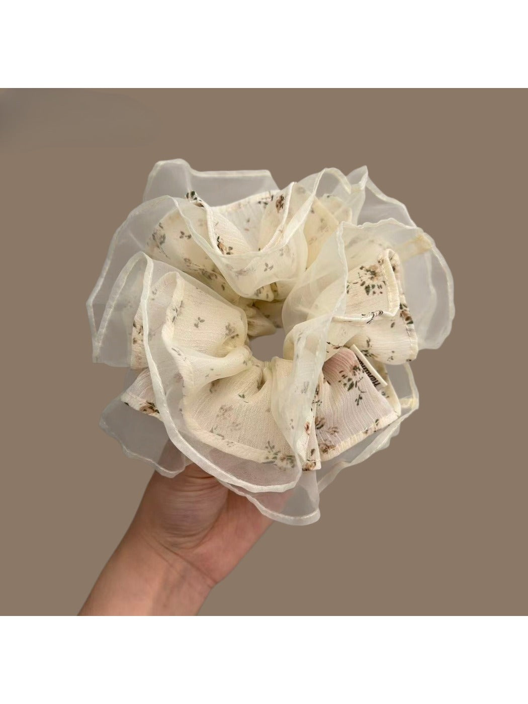White tulle scrunchie with tiny pink and green floral pattern on a white background