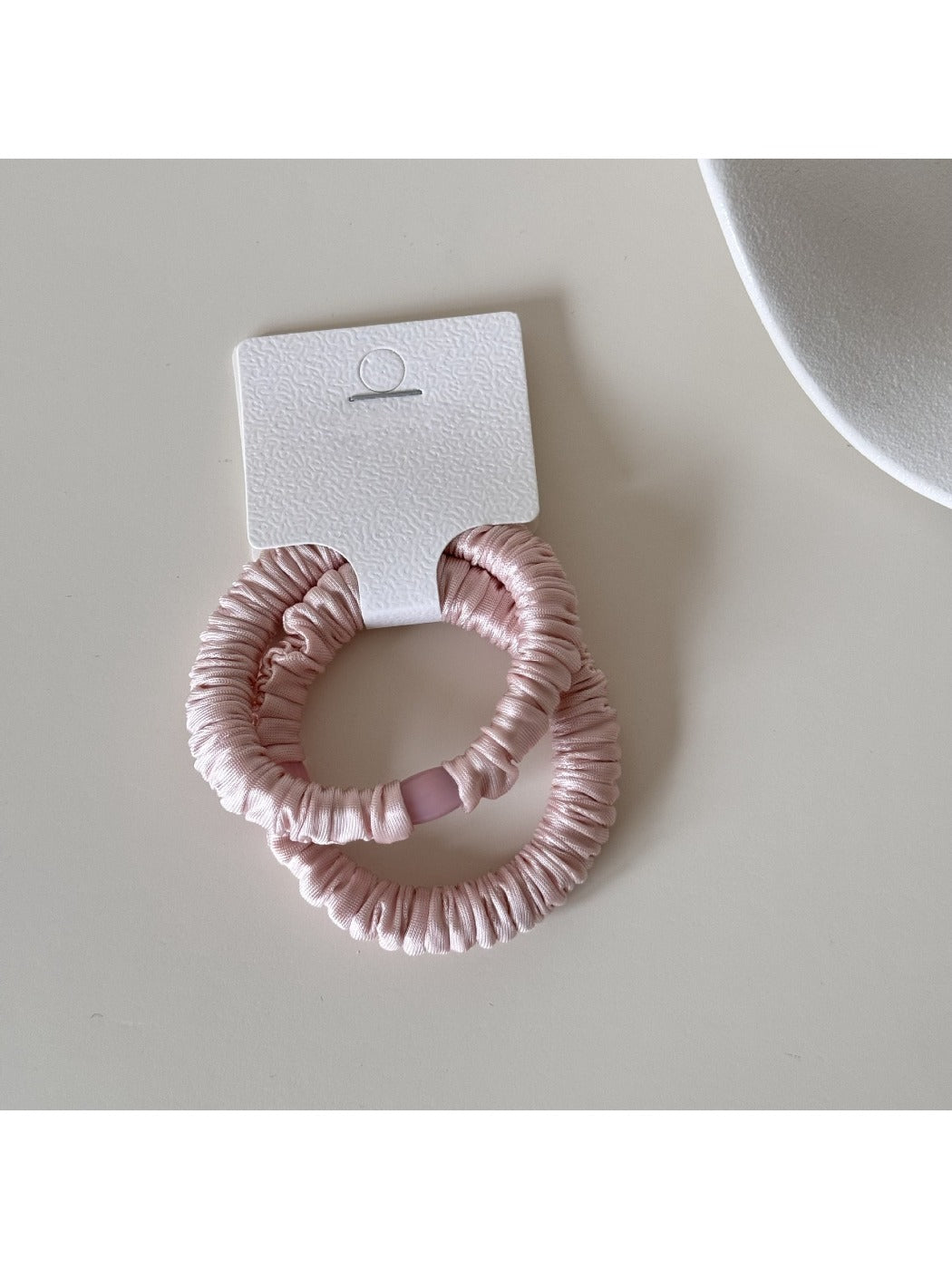 Set of three Gifty satin hair ties in pastel colors arranged in a circle