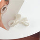 Beau bow shaped hair claw clip resting on a marble countertop
